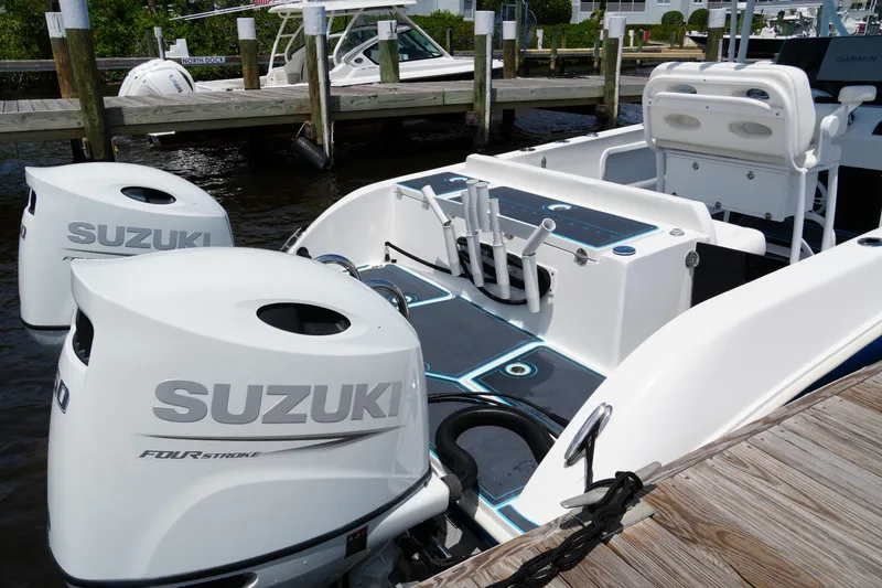 Slide: The Image of 2024 Twin Vee 240 GFX CC boat with Suzuki outboard engines at dock. - 20