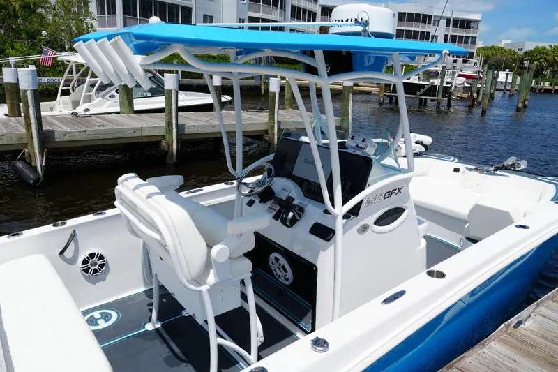 Slide: The Image of 2024 Twin Vee 240 GFX CC boat docked, featuring a sleek design and modern console. - 22