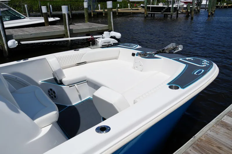 Slide: The Image of 2024 Twin Vee 240 GFX CC boat docked, featuring sleek design and spacious seating. - 24