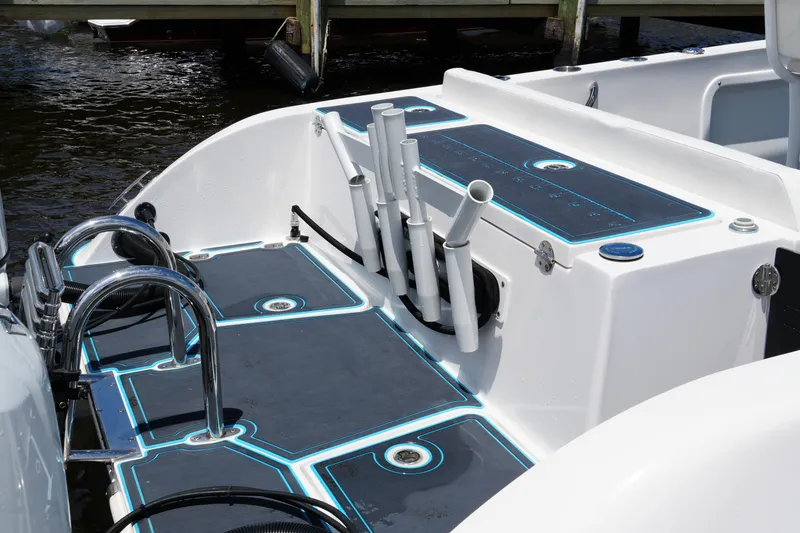 Slide: The Image of 2024 Twin Vee 240 GFX CC boat deck with rod holders and sleek design. - 25