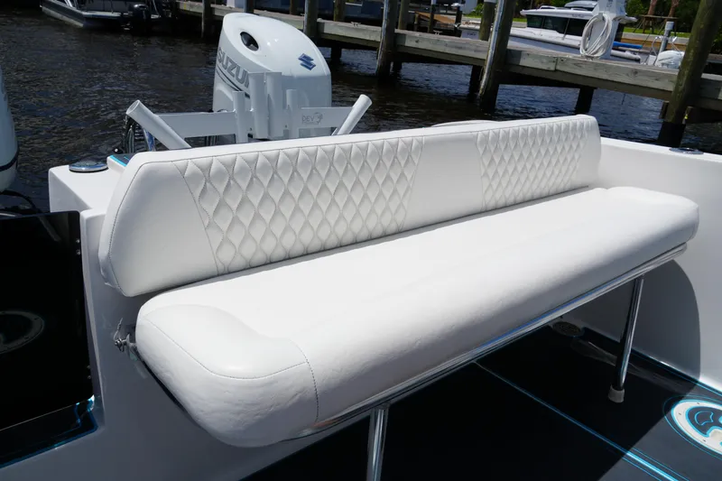 Slide: The Image of 2024 Twin Vee 240 GFX CC boat with white cushioned seating and Suzuki engine. - 27