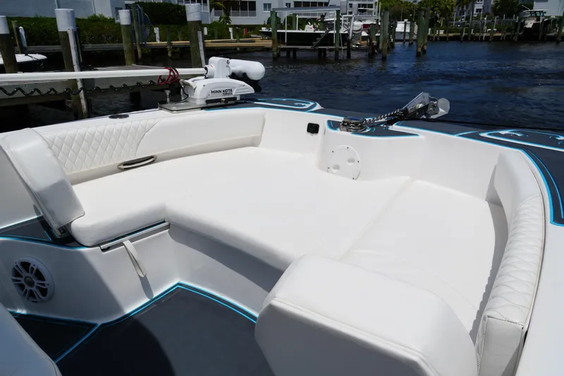 Slide: The Image of 2024 Twin Vee 240 GFX CC boat with white seating and modern design at a dock. - 33