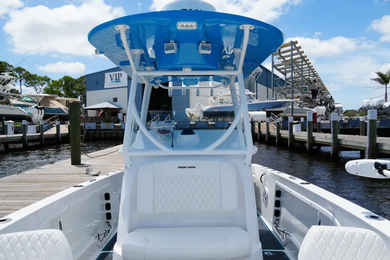 Slide: The Image of 2024 Twin Vee 240 GFX CC boat docked at marina under blue sky. - 36