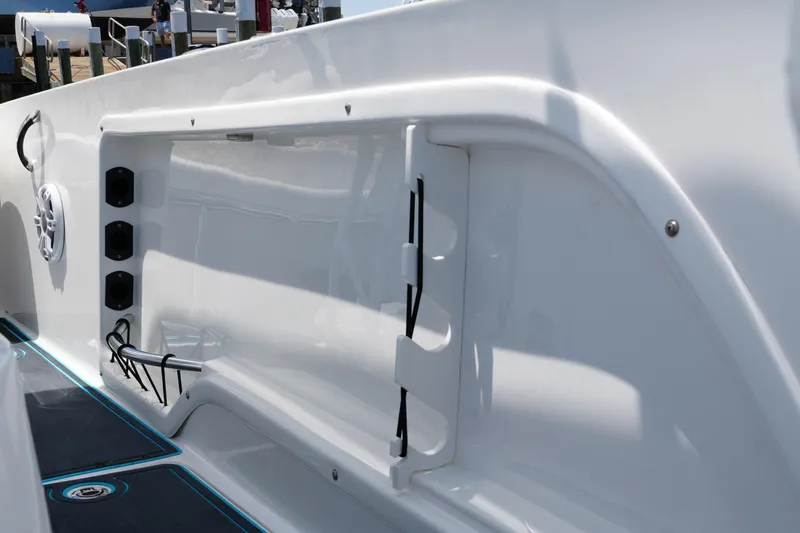 Slide: The Image of 2024 Twin Vee 240 GFX CC boat interior detail with speaker and storage compartments. - 38