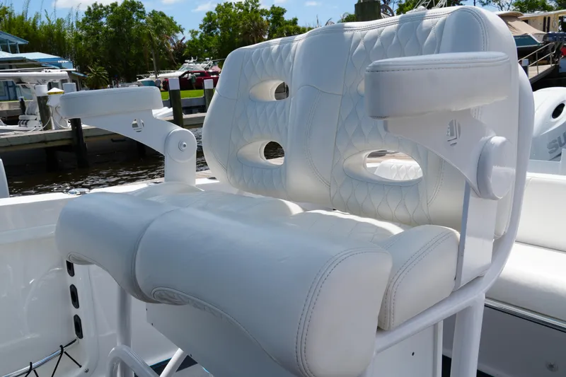 Slide: The Image of 2024 Twin Vee 240 GFX CC boat seat with white cushioned design at marina. - 41