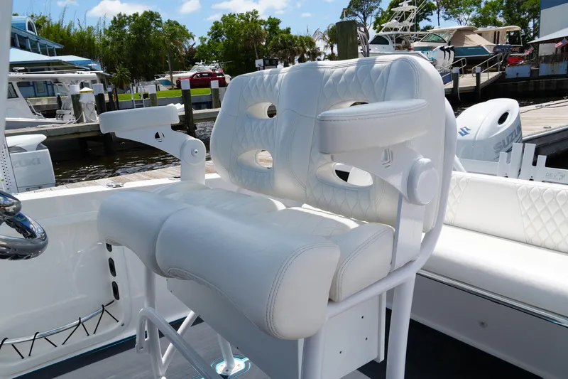 Slide: The Image of 2024 Twin Vee 240 GFX CC boat with white cushioned seating at a marina. - 42