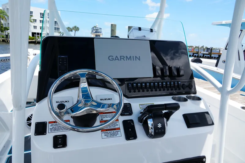 Slide: The Image of 2024 Twin Vee 240 GFX CC boat console with Garmin navigation and Suzuki controls. - 43