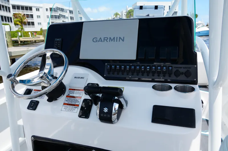 Slide: The Image of 2024 Twin Vee 240 GFX CC boat console with Garmin display and Suzuki controls. - 46