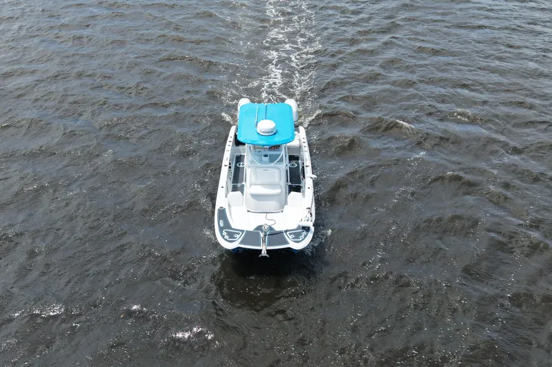 Slide: The Image of 2024 Twin Vee 240 GFX CC boat cruising on open water, aerial view. - 6