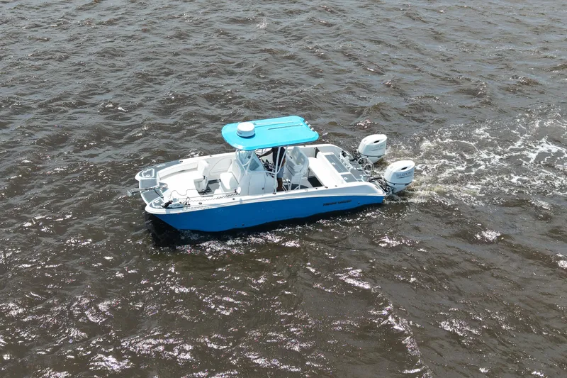 Slide: The Image of 2024 Twin Vee 240 GFX CC boat cruising on open water. - 7