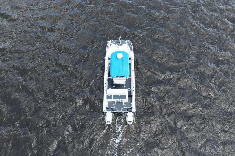 Slide: The Image of Aerial view of 2024 Twin Vee 240 GFX CC boat navigating through dark waters. - 8
