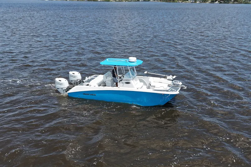 Slide: The Image of 2024 Twin Vee 240 GFX CC boat cruising on open water, featuring dual Suzuki engines. - 9