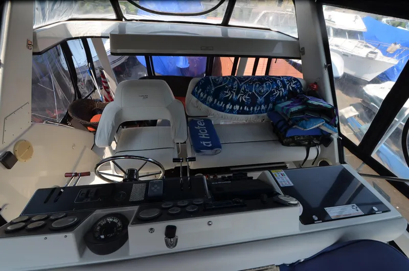Slide: The Image of Interior of 1991 Carver 33 Aft Cabin with helm and seating area. - 11