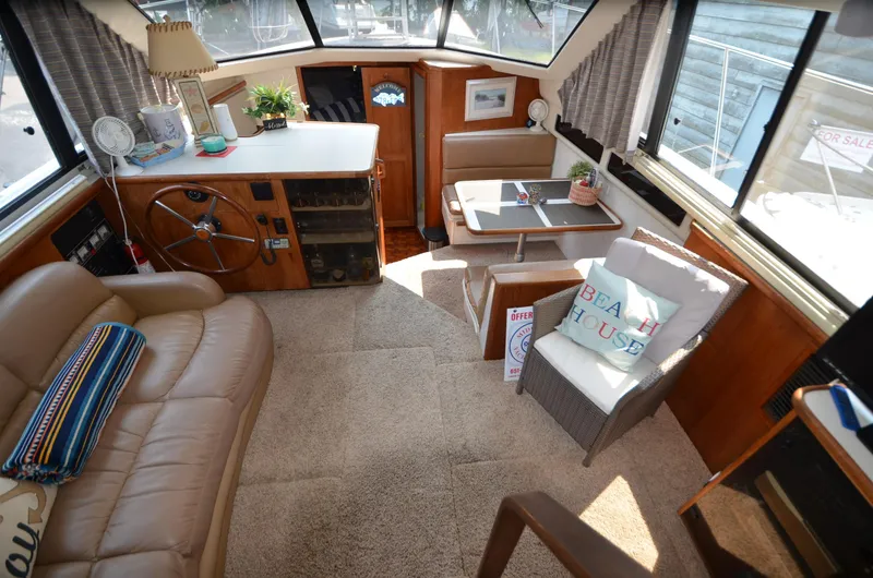 Slide: The Image of Interior of 1991 Carver 33 Aft Cabin with cozy seating and helm. - 20