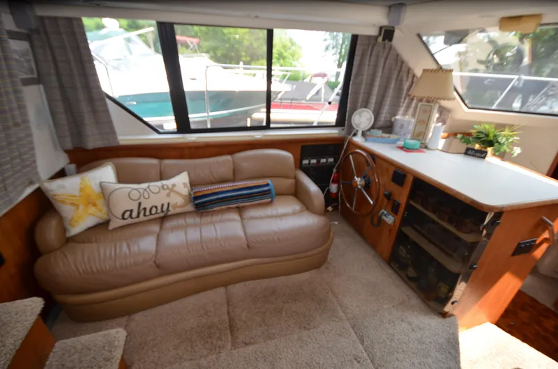 Slide: The Image of Interior of 1991 Carver 33 Aft Cabin with cozy seating and nautical decor. - 23