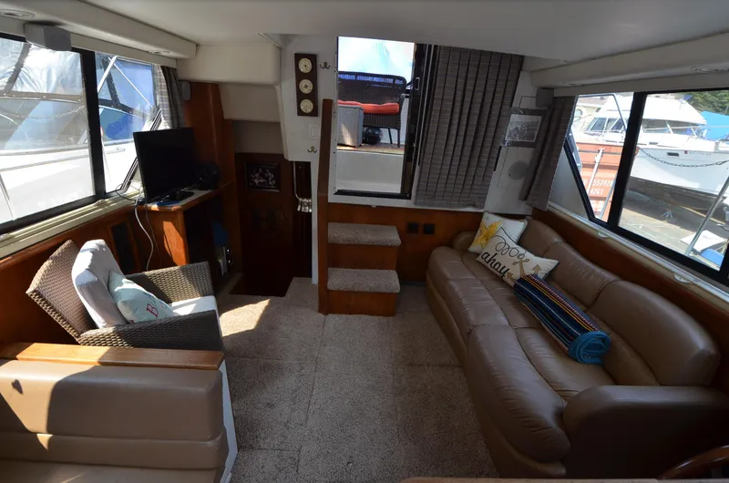 Slide: The Image of Interior of 1991 Carver 33 Aft Cabin yacht with cozy seating and large windows. - 24