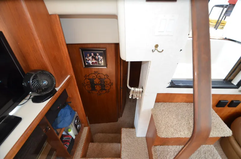 Slide: The Image of Interior of 1991 Carver 33 Aft Cabin with carpeted stairs and wooden cabinetry. - 25