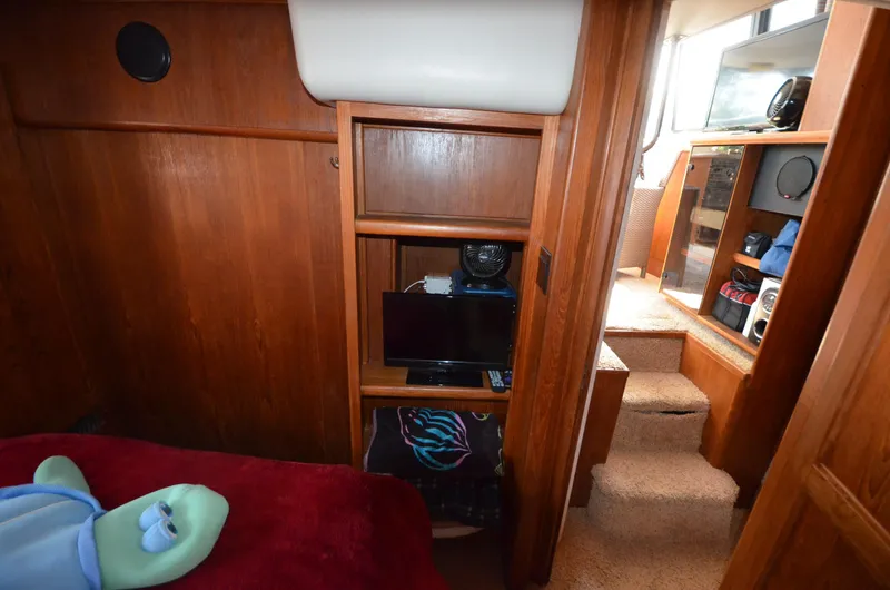 Slide: The Image of 1991 Carver 33 Aft Cabin interior with wood paneling and cozy furnishings. - 28