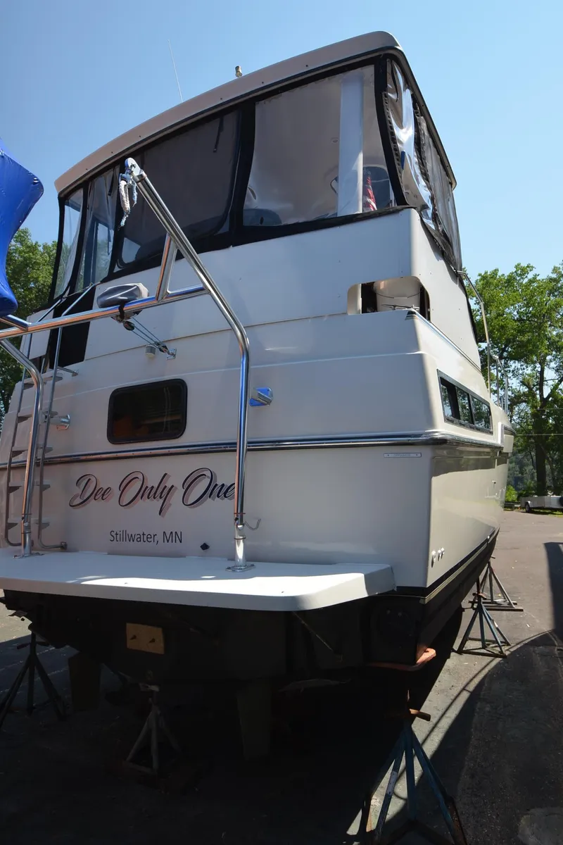 Slide: The Image of 1991 Carver 33 Aft Cabin boat on stands, rear view, sunny day. - 5