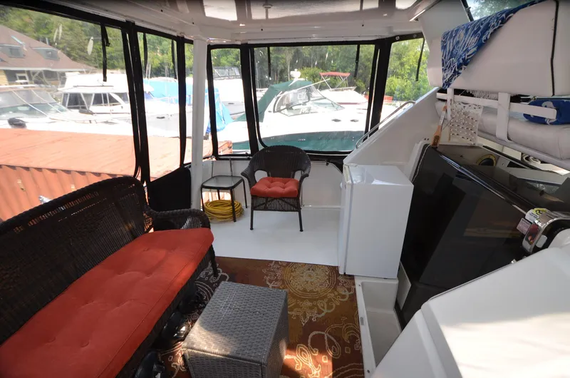 Slide: The Image of 1991 Carver 33 Aft Cabin interior with seating, windows, and storage. - 9