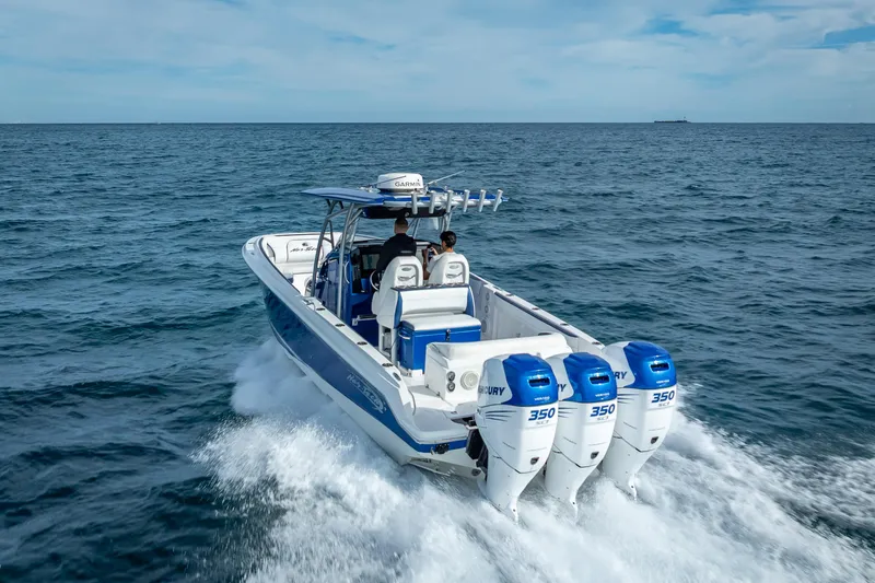 Slide: The Image of 2015 Nor-Tech 340 Sport Center Console boat cruising on open water. - 11