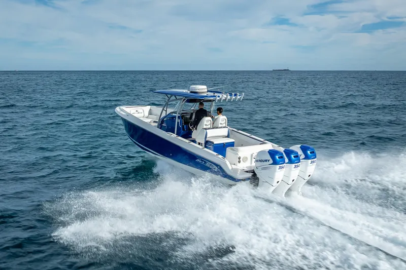 Slide: The Image of 2015 Nor-Tech 340 Sport Center Console boat cruising on open water. - 12
