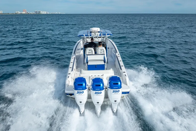 Slide: The Image of 2015 Nor-Tech 340 Sport Center Console cruising on open water. - 13
