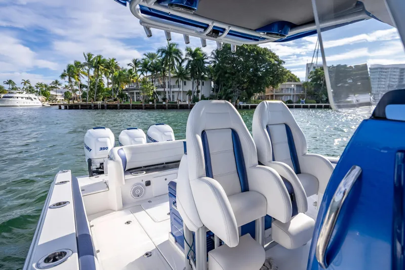 Slide: The Image of 2015 Nor-Tech 340 Sport Center Console boat with luxurious seating and powerful engines. - 14