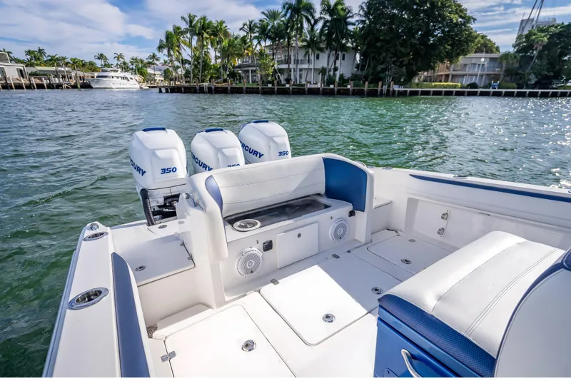 Slide: The Image of 2015 Nor-Tech 340 Sport Center Console boat with triple Mercury 350 engines on water. - 15