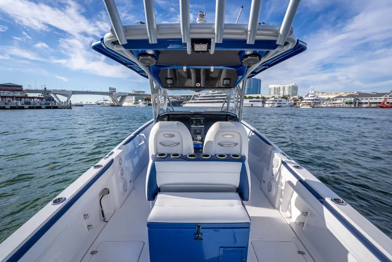 Slide: The Image of 2015 Nor-Tech 340 Sport Center Console boat on water, cityscape background. - 18