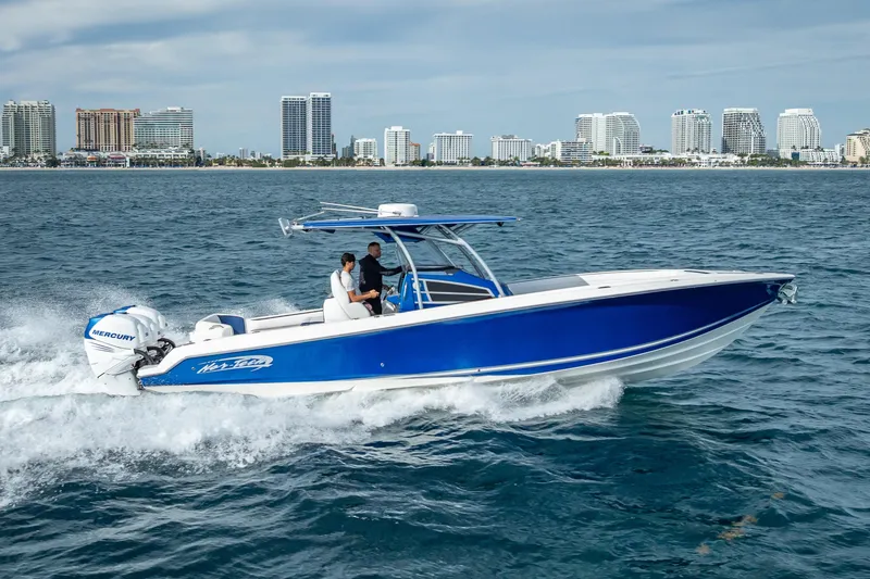 Slide: The Image of 2015 Nor-Tech 340 Sport Center Console boat cruising near city skyline. - 22
