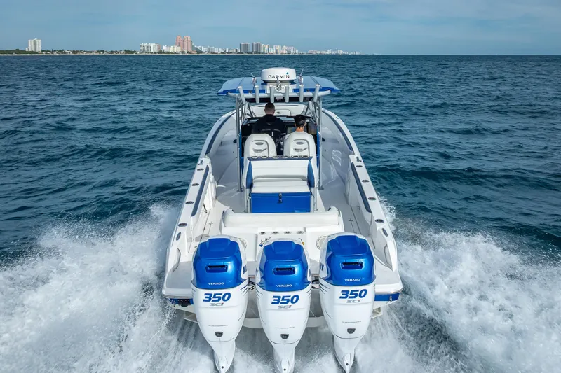 Slide: The Image of 2015 Nor-Tech 340 Sport Center Console cruising on open water with triple engines. - 24