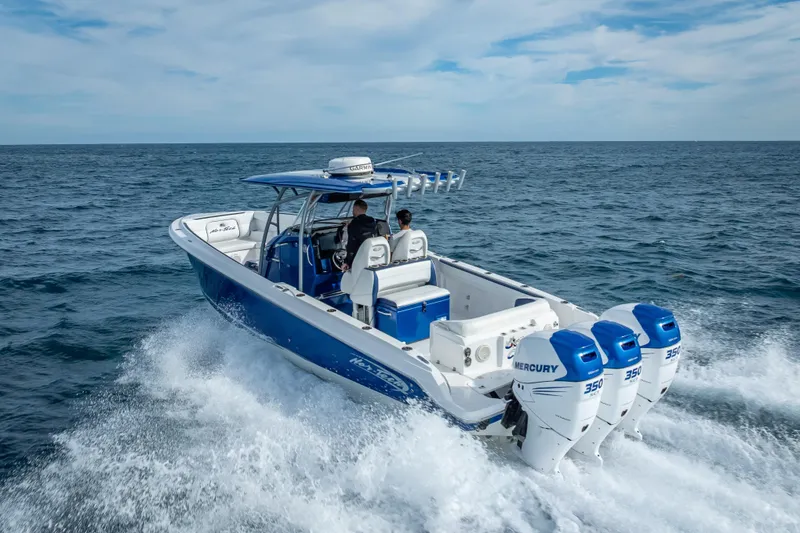 Slide: The Image of 2015 Nor-Tech 340 Sport Center Console boat cruising on open ocean. - 25