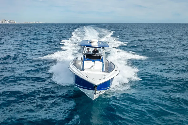 Slide: The Image of 2015 Nor-Tech 340 Sport Center Console cruising on open ocean waters. - 27