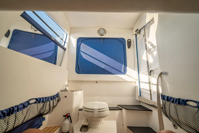 Slide: The Image of Interior of 2015 Nor-Tech 340 Sport Center Console boat with toilet and storage. - 31