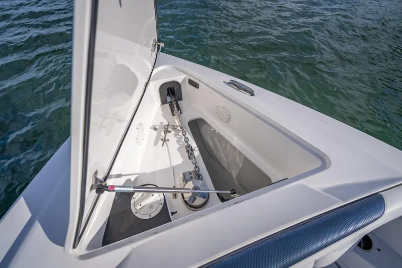 Slide: The Image of 2015 Nor-Tech 340 Sport Center Console anchor compartment open on calm water. - 32