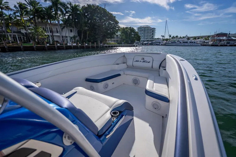 Slide: The Image of 2015 Nor-Tech 340 Sport Center Console boat on water, featuring spacious seating and scenic view. - 33