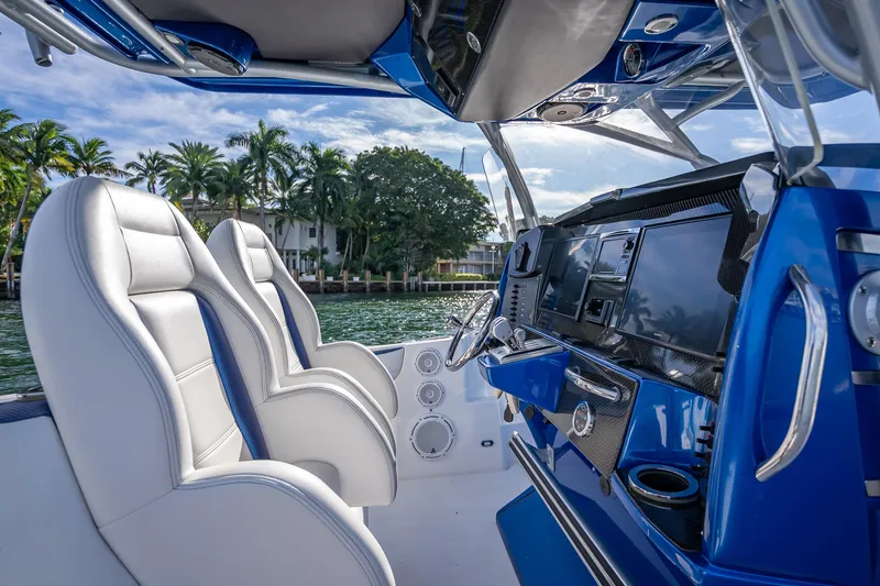 Slide: The Image of 2015 Nor-Tech 340 Sport Center Console interior with sleek blue and white design. - 41