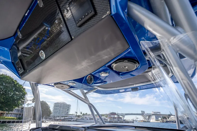 Slide: The Image of 2015 Nor-Tech 340 Sport Center Console boat interior with blue accents and speakers. - 42