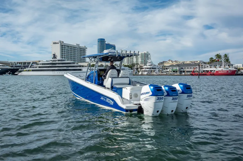 Slide: The Image of 2015 Nor-Tech 340 Sport Center Console boat with triple Mercury engines on water. - 6