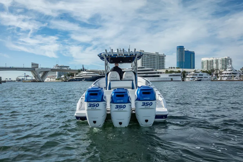 Slide: The Image of 2015 Nor-Tech 340 Sport Center Console boat on water, cityscape background. - 8