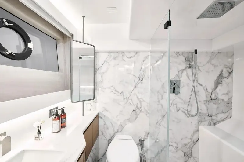 Slide: The Image of Luxurious Oceanwalker S60 2026 yacht bathroom with marble walls and modern fixtures. - 20
