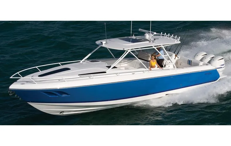 The Image of 2015 Intrepid 400 Cuddy boat docked at marina under clear blue sky. - 0