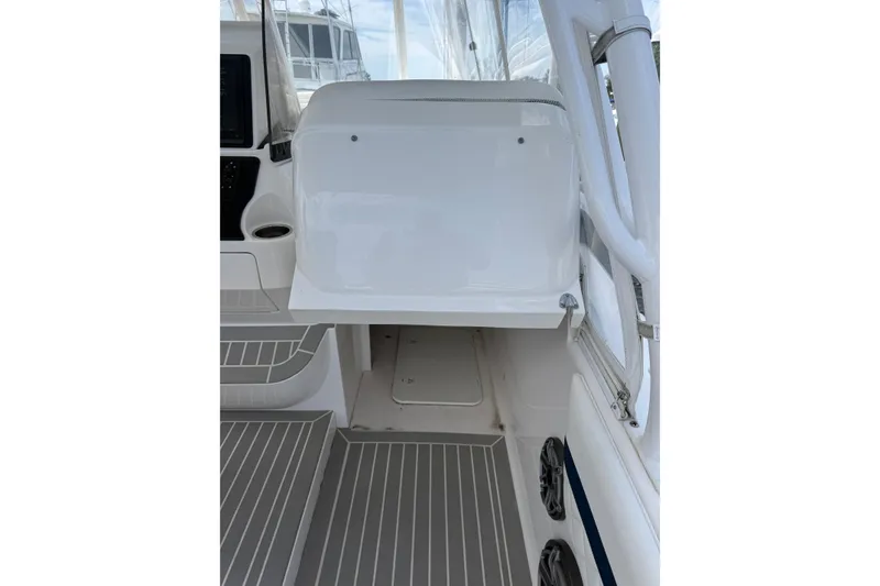 Slide: The Image of Interior view of a 2015 Intrepid 400 Cuddy boat, featuring sleek white surfaces and modern design. - 10