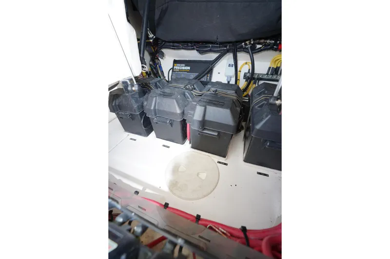 Slide: The Image of Battery compartment of a 2015 Intrepid 400 Cuddy boat, featuring multiple battery boxes. - 101