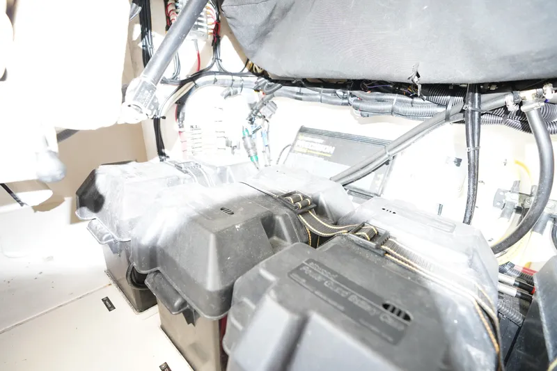Slide: The Image of Engine compartment of a 2015 Intrepid 400 Cuddy, showcasing battery setup and wiring. - 103