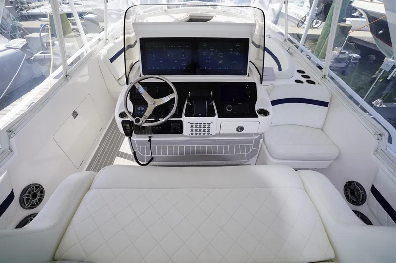 Slide: The Image of 2015 Intrepid 400 Cuddy helm with modern controls and luxurious seating. - 104