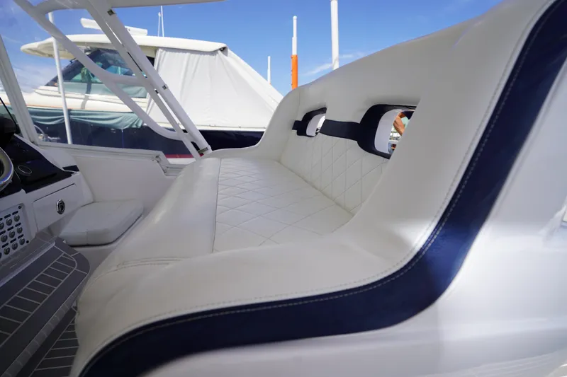 Slide: The Image of Luxurious white seating on 2015 Intrepid 400 Cuddy boat, featuring elegant blue accents. - 105