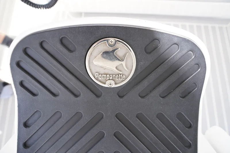Slide: The Image of Pompanette logo on Intrepid 400 Cuddy 2015 boat seat with textured black surface. - 107