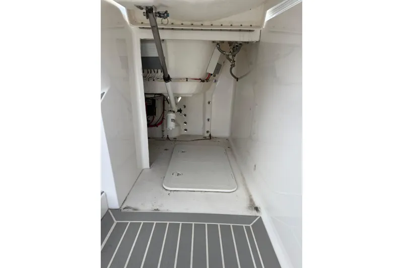 Slide: The Image of Interior view of a 2015 Intrepid 400 Cuddy boat, showcasing storage and mechanical components. - 11